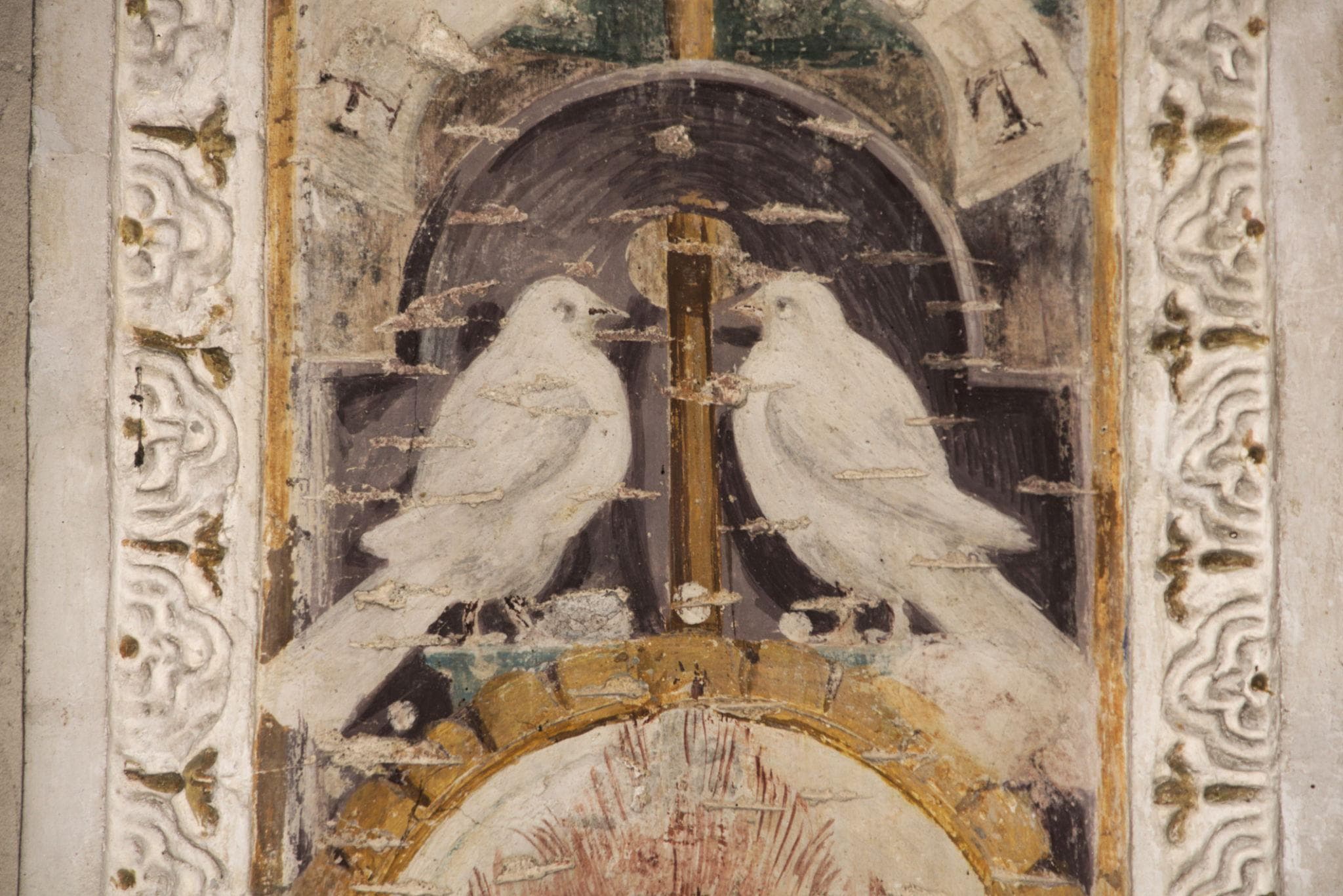 Decorative image: two doves in a painted arch.